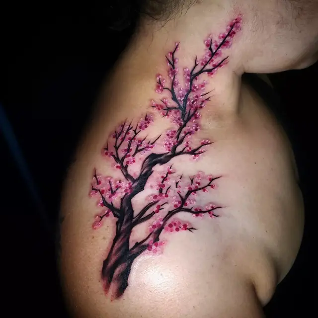Cherry blossom branch tattoo by Chris Carp at Heart & Sword Tattoo