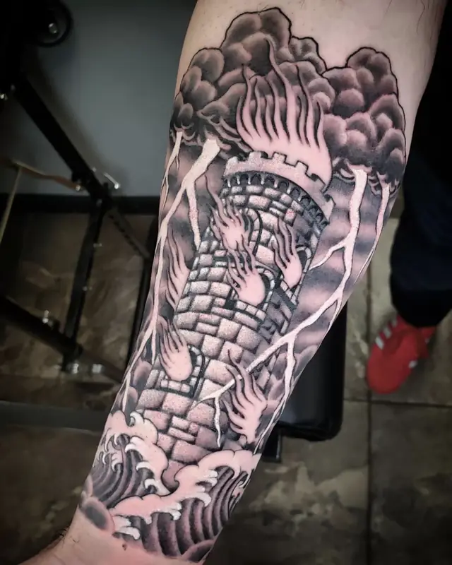 Black and gray lighthouse in a storm by Chris Carp at Heart & Sword Tattoo