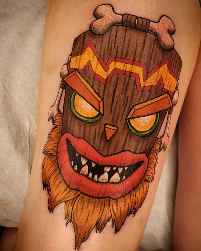 Color tiki mask tattoo by Chris Carp at Heart & Sword Tattoo