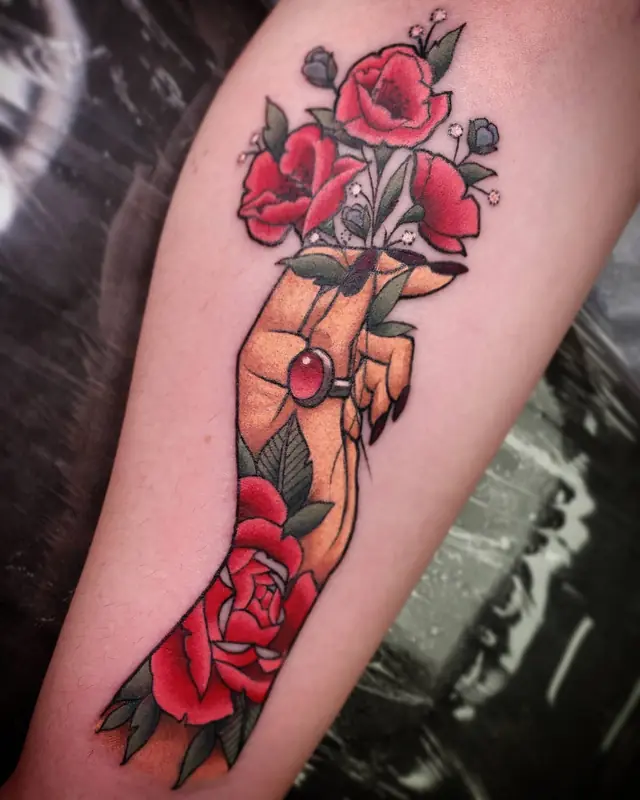 Traditional color hand holding red roses by Chris Carp at Heart & Sword Tattoo