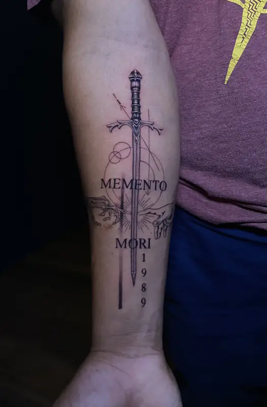Fine line sword with 'Memento Mori' by Dina at Heart & Sword Tattoo