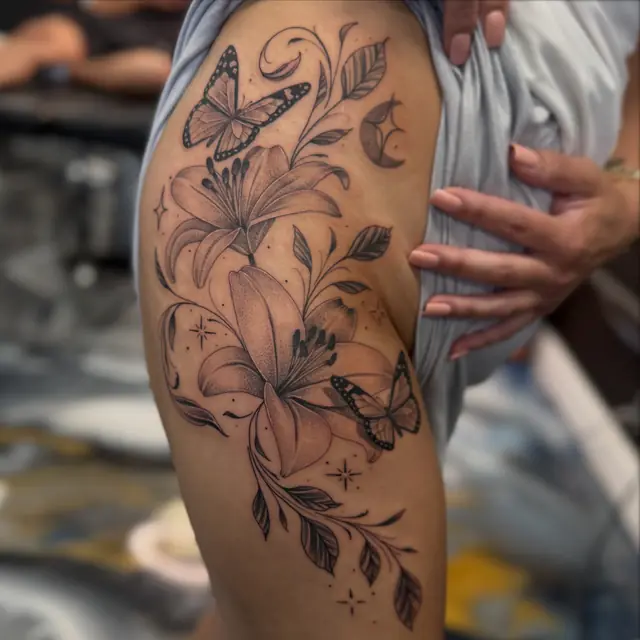 Fine line lilies and butterflies by Johnny at Heart & Sword Tattoo
