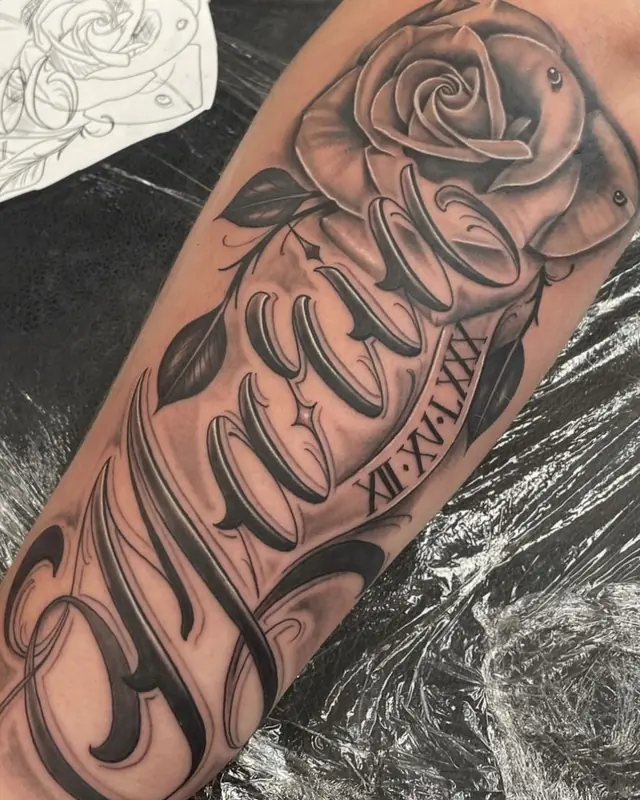 Custom script lettering with rose by Johnny at Heart & Sword Tattoo