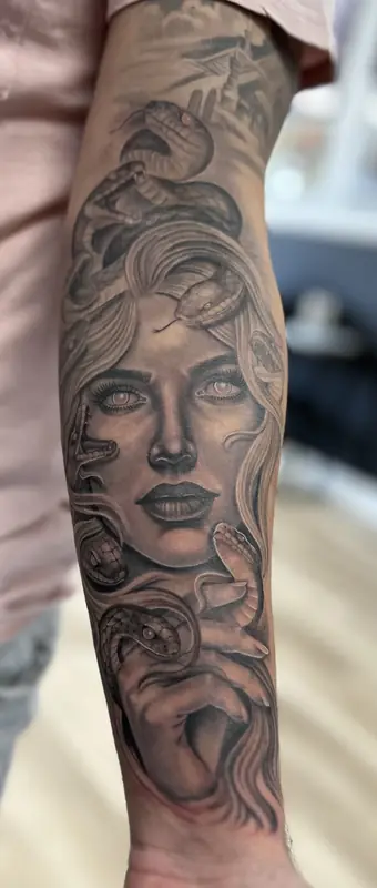 Black and gray woman portrait forearm by Johnny at Heart & Sword Tattoo